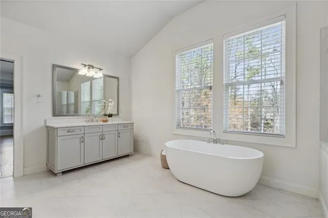 a bathroom with a tub and shower