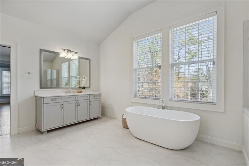 3185 Casteel Road Marietta, GA 30062 - Photo 16 of 20 a spacious bathroom with sink double vanity granite tub shower and mirror