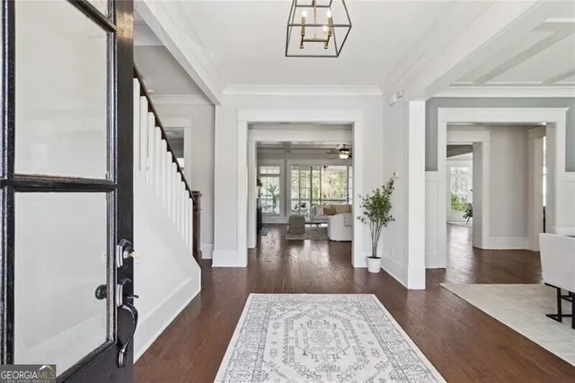 wooden floor with a chandelier in a living room