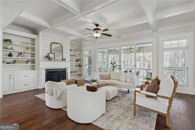 a living room with furniture a fireplace and a chandelier