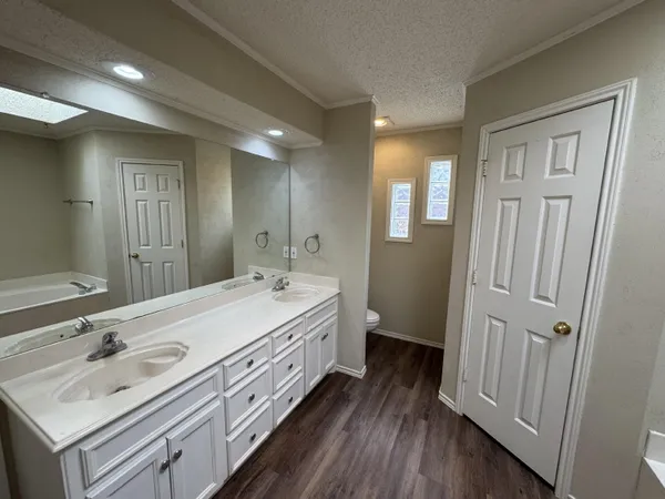 a spacious bathroom with a double vanity sink and a mirror