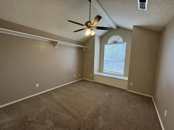 a view of a livingroom with a ceiling fan and window