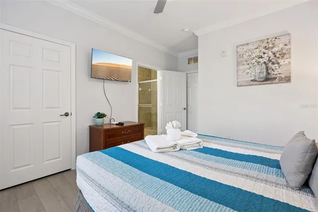 a bedroom with bed and a chandelier