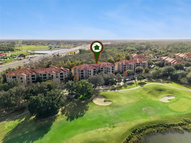 a view of a city with lawn chairs and large trees