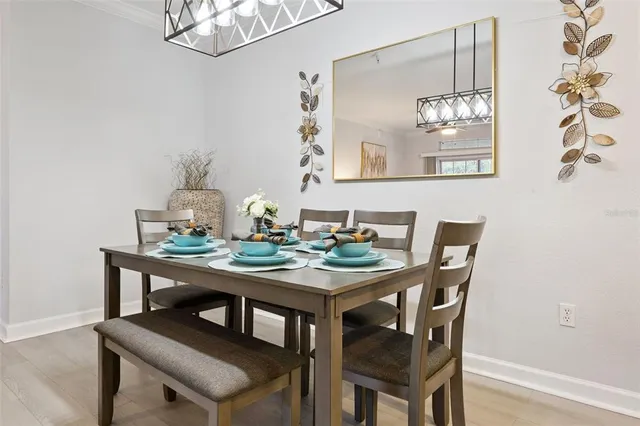 a view of a dining room with furniture and a chandelier