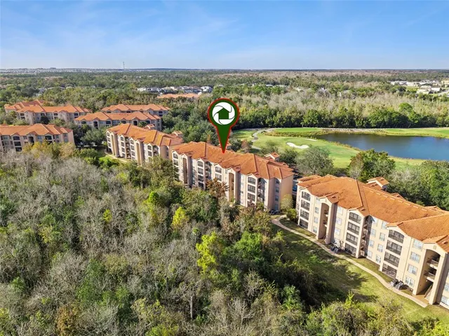 a house with swimming pool and tall trees