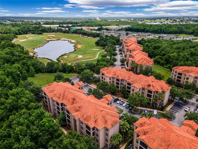 a front view of a house with plants and trees