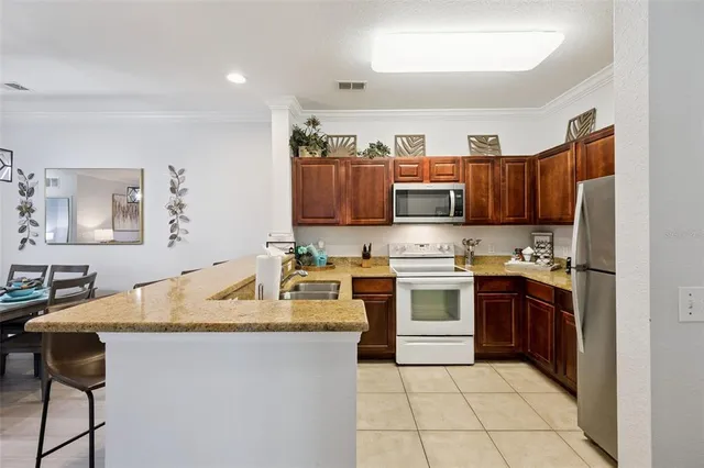 a kitchen with a refrigerator sink and wooden cabinets