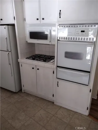 a kitchen with a stove and a microwave