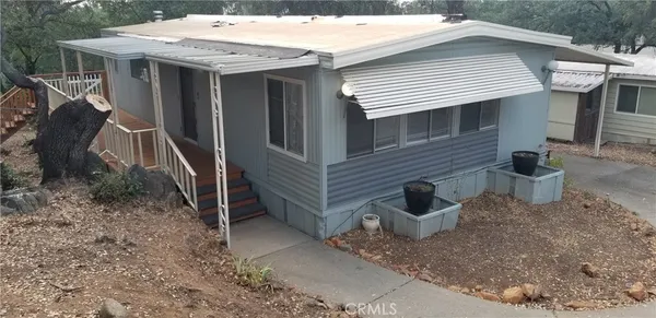 a view of a house with a yard and sitting area