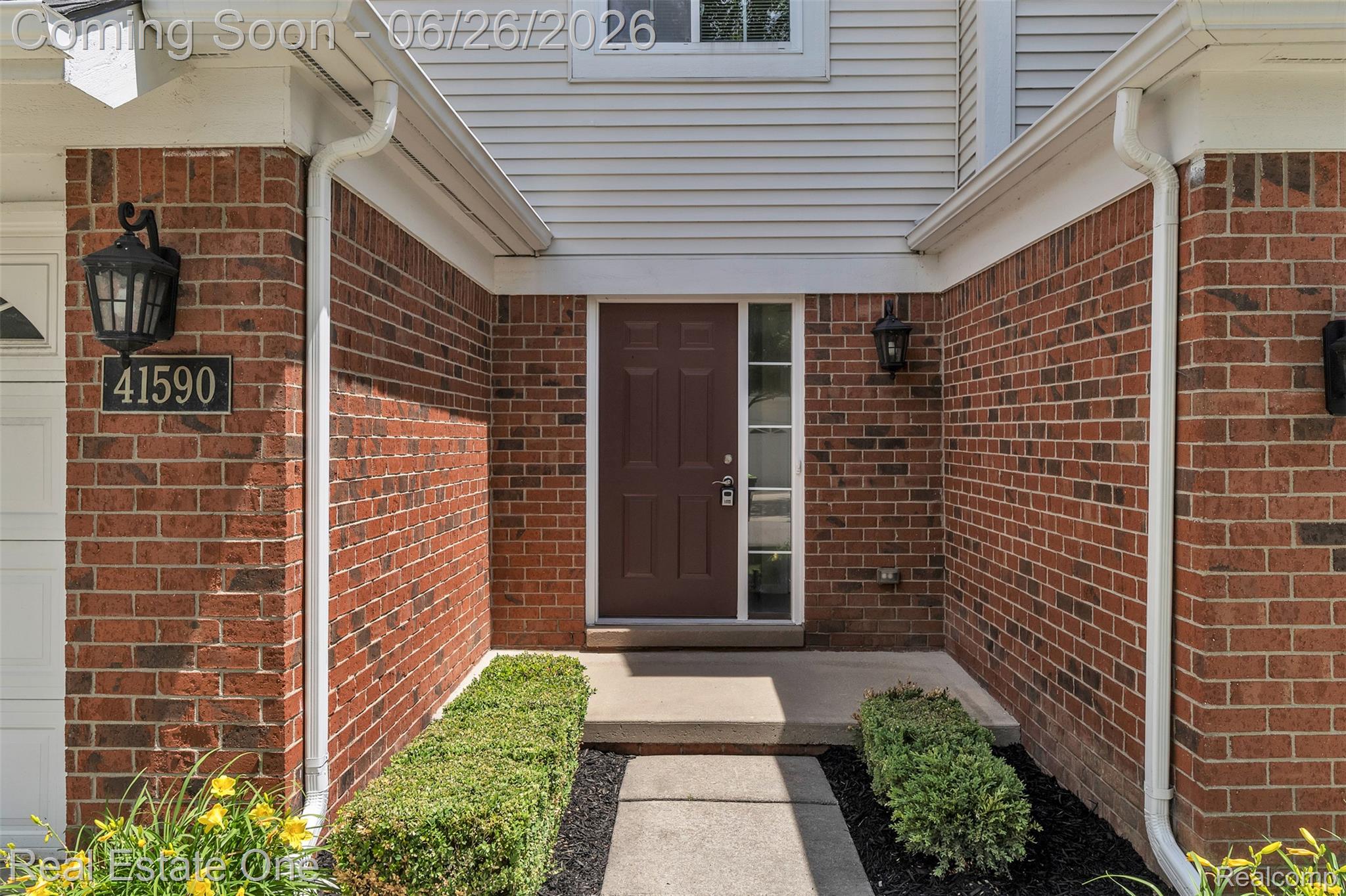 41590 Mitchell Road Novi, MI 48377 - Photo 42 of 45 Brick and siding exterior featuring a dark brown entry door with sidelights