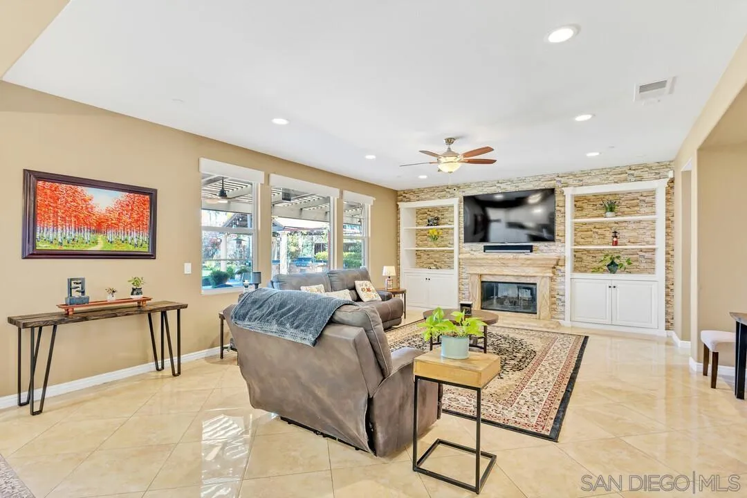 14622 Whispering Ridge Road San Diego, CA 92131 - Photo 21 of 75 a living room with fireplace furniture and a flat screen tv