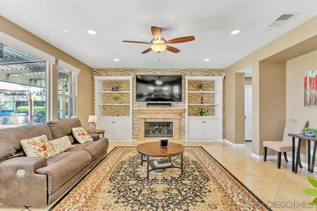 14622 Whispering Ridge Road San Diego, CA 92131 - Photo 23 of 75 a living room with furniture and a fireplace