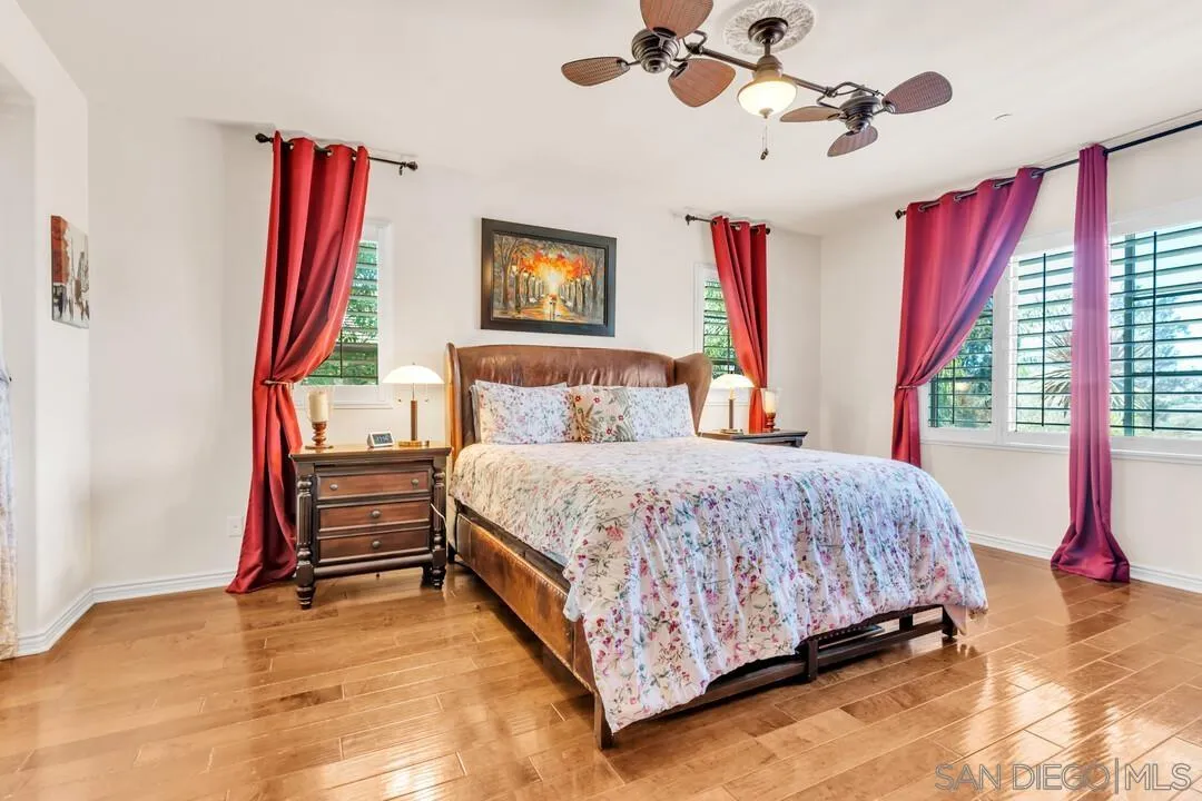 14622 Whispering Ridge Road San Diego, CA 92131 - Photo 32 of 75 a bedroom with a bed and a chandelier