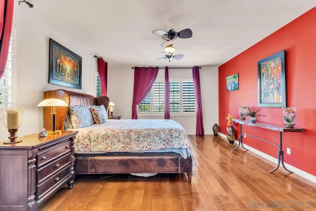 14622 Whispering Ridge Road San Diego, CA 92131 - Photo 33 of 75 a spacious bedroom with a bed and wooden floor