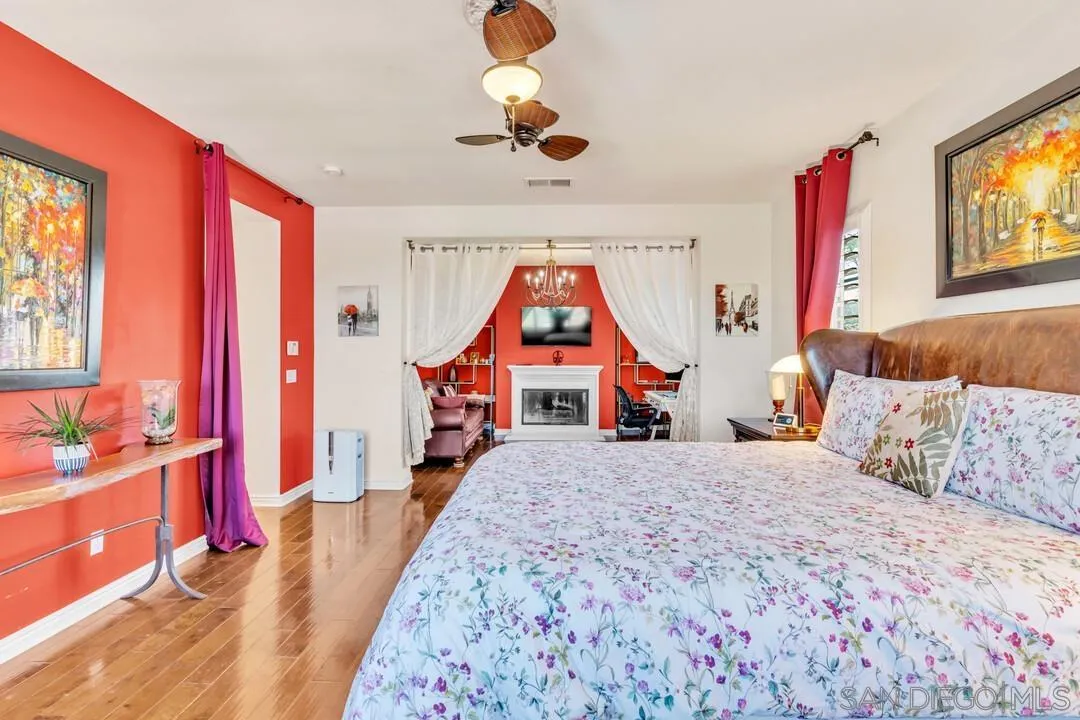 14622 Whispering Ridge Road San Diego, CA 92131 - Photo 34 of 75 a bedroom with a bed and a chandelier