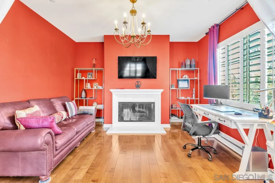 14622 Whispering Ridge Road San Diego, CA 92131 - Photo 35 of 75 a living room with furniture a fireplace and a flat screen tv