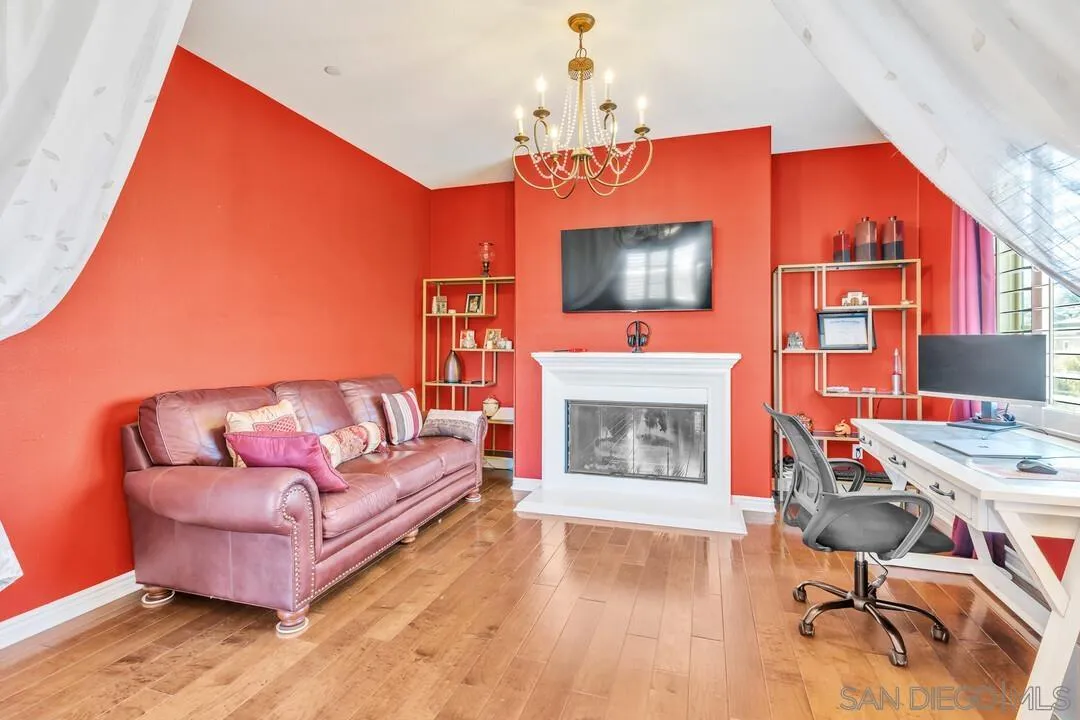 14622 Whispering Ridge Road San Diego, CA 92131 - Photo 36 of 75 a living room with furniture a fireplace and a flat screen tv