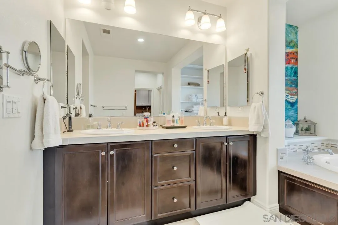 14622 Whispering Ridge Road San Diego, CA 92131 - Photo 40 of 75 a bathroom with a sink double vanity and a mirror