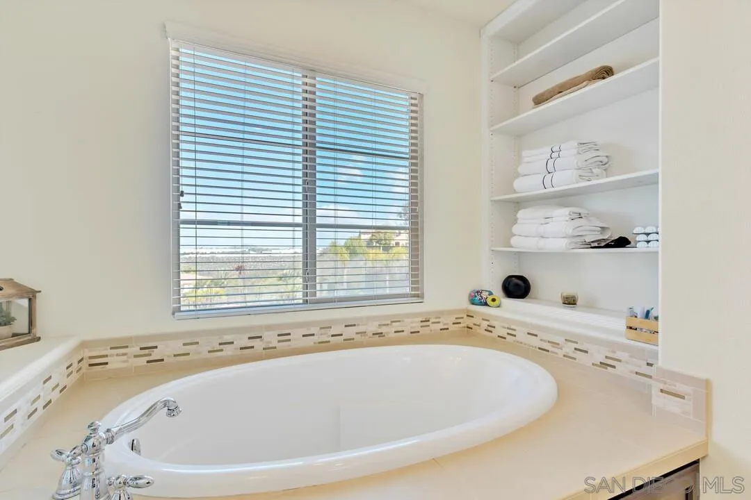 14622 Whispering Ridge Road San Diego, CA 92131 - Photo 41 of 75 a bathroom with a tub and a sink
