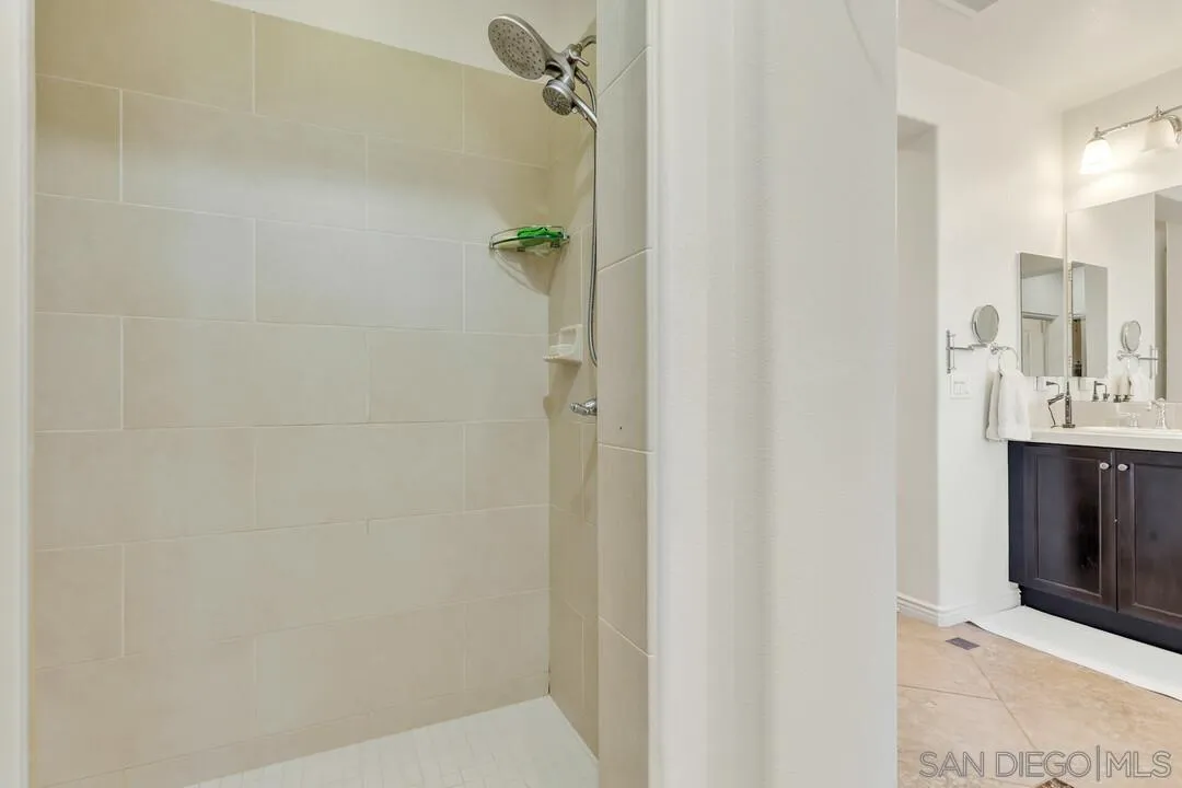 14622 Whispering Ridge Road San Diego, CA 92131 - Photo 42 of 75 a bathroom with a sink and mirror