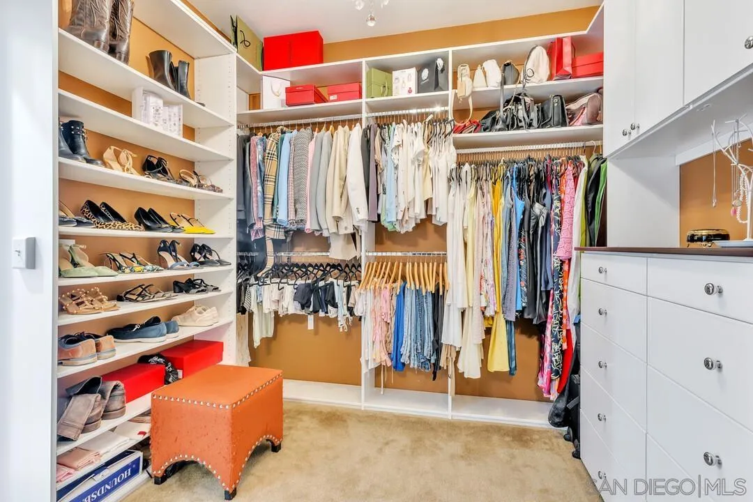 14622 Whispering Ridge Road San Diego, CA 92131 - Photo 44 of 75 a view of walk in closet with clothes and shoes