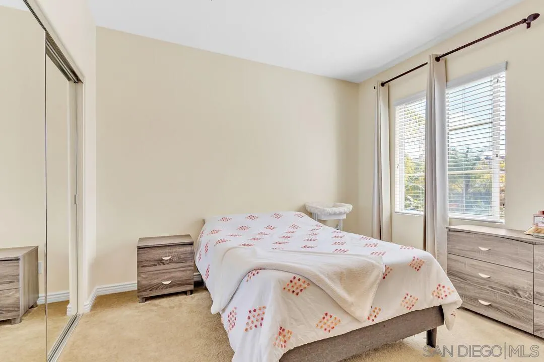 14622 Whispering Ridge Road San Diego, CA 92131 - Photo 45 of 75 a bedroom with a bed and wooden floor