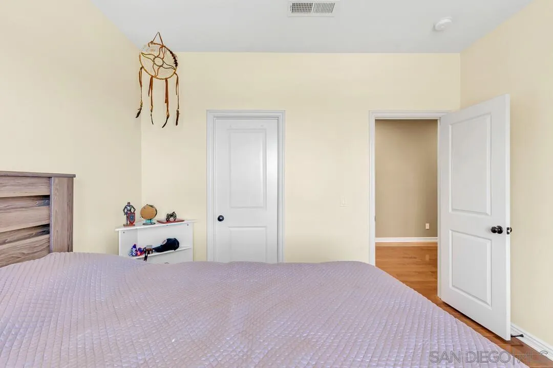 14622 Whispering Ridge Road San Diego, CA 92131 - Photo 52 of 75 a bedroom with a bed and hallway
