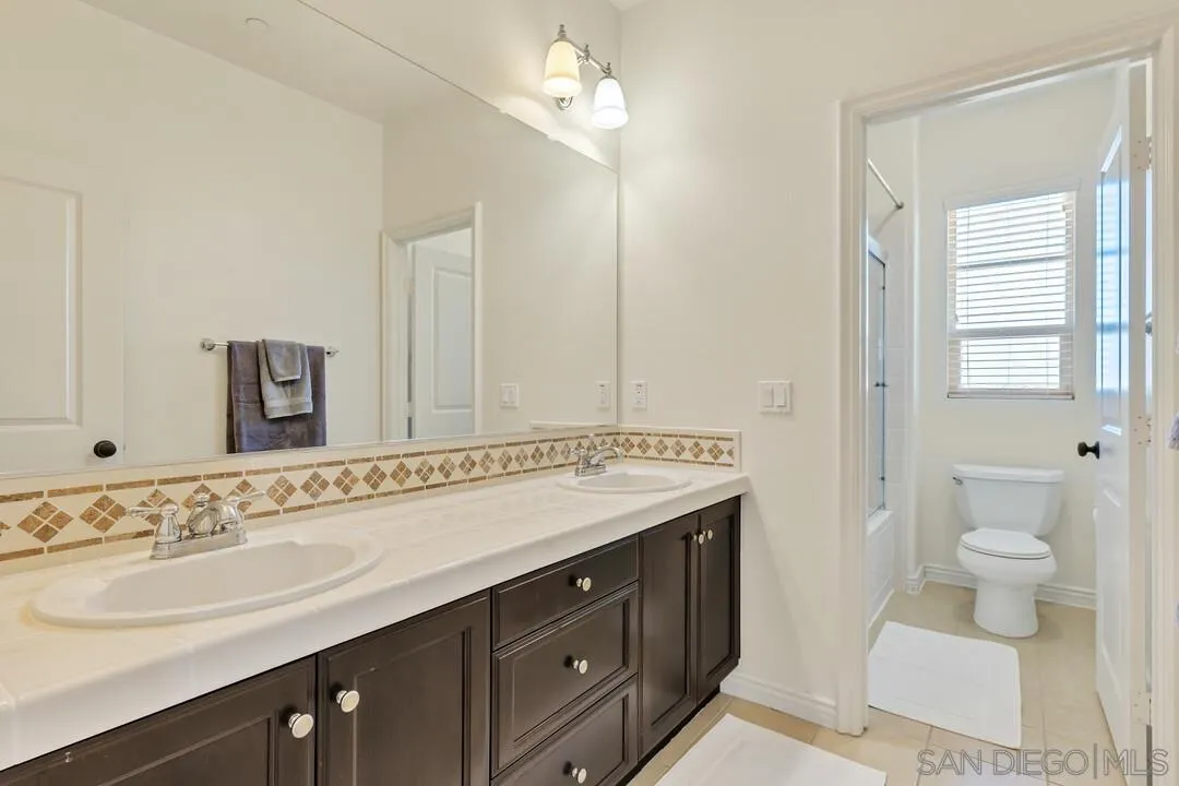14622 Whispering Ridge Road San Diego, CA 92131 - Photo 53 of 75 a bathroom with a sink and a mirror
