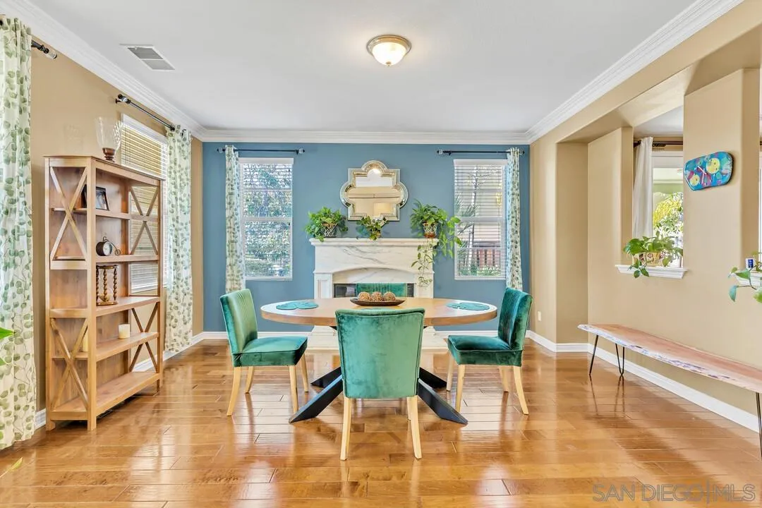 14622 Whispering Ridge Road San Diego, CA 92131 - Photo 6 of 75 a view of a dining room with furniture a chandelier and wooden floor