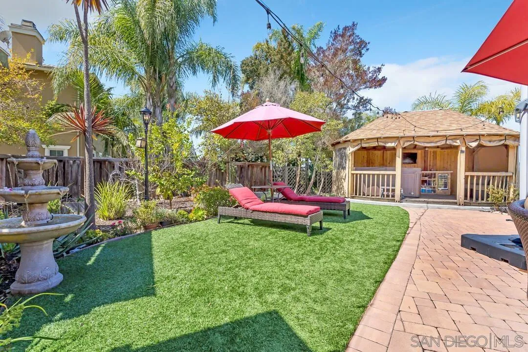14622 Whispering Ridge Road San Diego, CA 92131 - Photo 63 of 75 a view of a house with backyard sitting area and garden