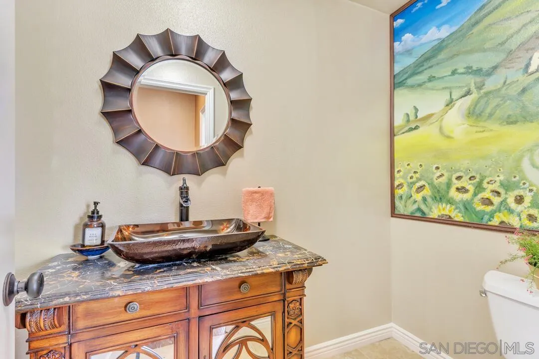 14622 Whispering Ridge Road San Diego, CA 92131 - Photo 10 of 75 a bathroom with a granite countertop sink and a mirror