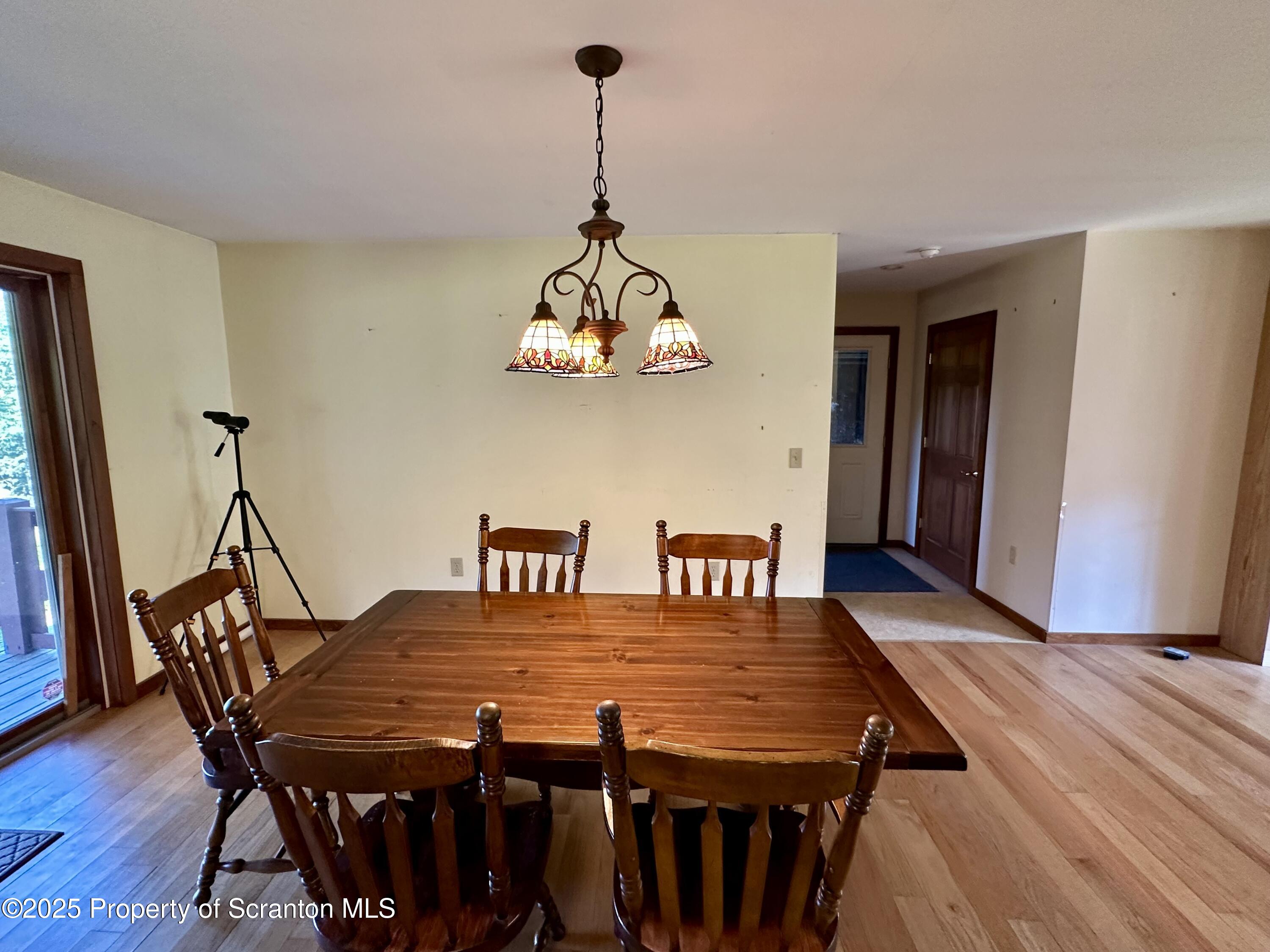 5290 Irish Hill Road Montrose, PA 18801 - Photo 21 of 67 a dining room with a wooden table and chairs