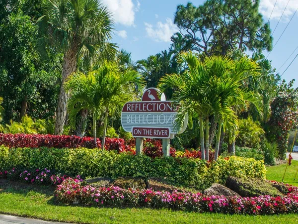 a view of sign board with flower garden