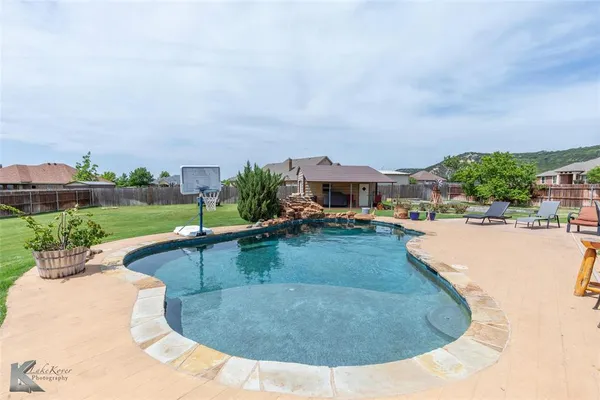 a view of a swimming pool with a patio