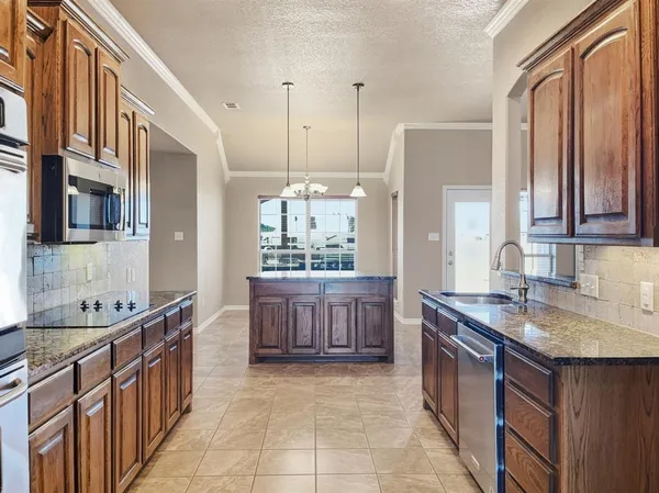 a kitchen with granite countertop a sink and a granite counter top