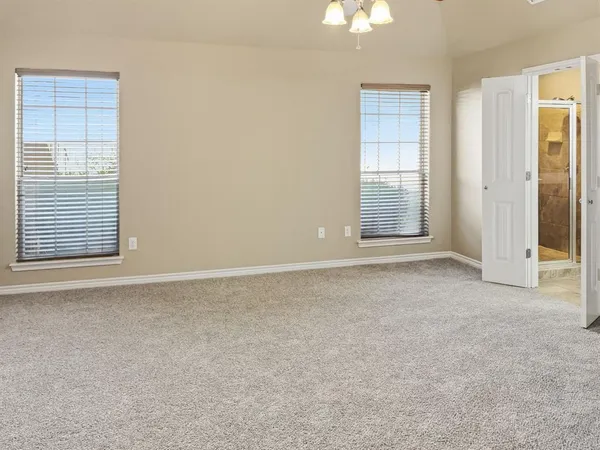a bathroom with a granite countertop sink a mirror and a bathtub