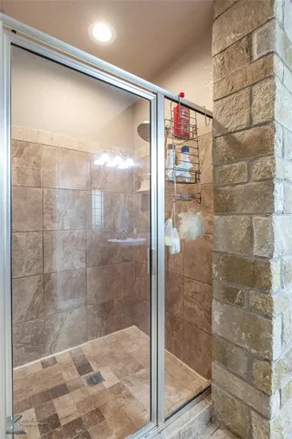a bathroom with a glass shower door