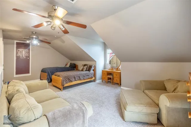a bedroom with furniture and a chandelier