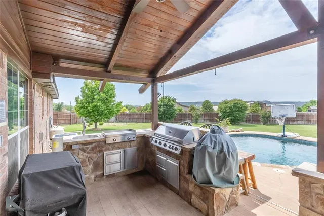 a view of a chairs and table in patio with a backyard