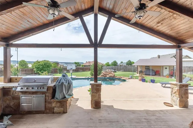 a view of a patio with a dining table and chairs