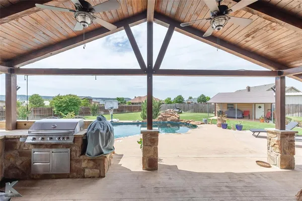 an outdoor view of house with swimming pool and furniture