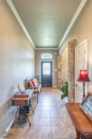 a living room with furniture and flowers