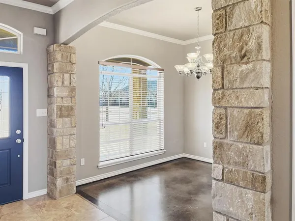 an empty room with windows and a fireplace
