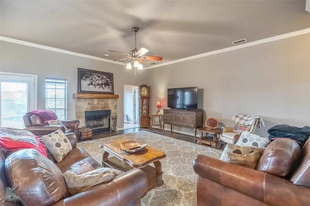 a living room with furniture fireplace and a table