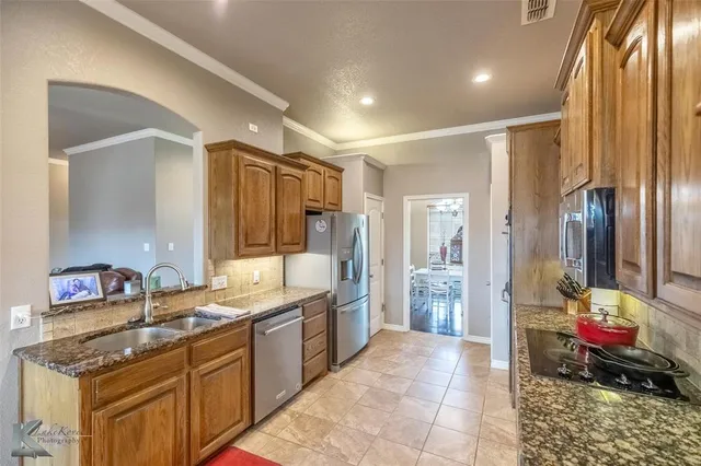 a bathroom with a granite countertop sink a mirror and a shower