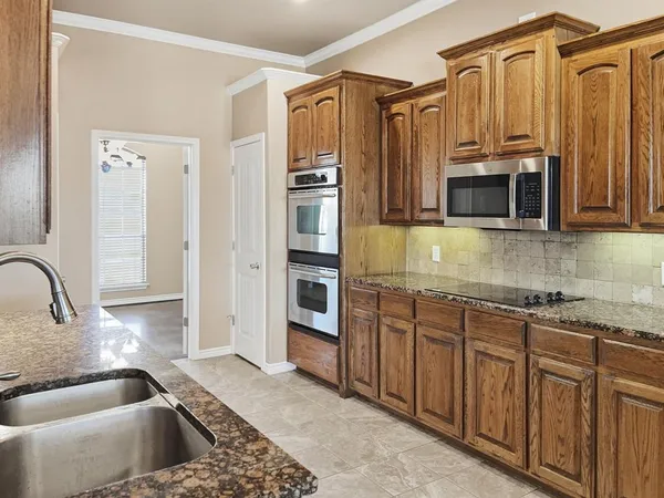 a spacious bathroom with a granite countertop sink and a mirror
