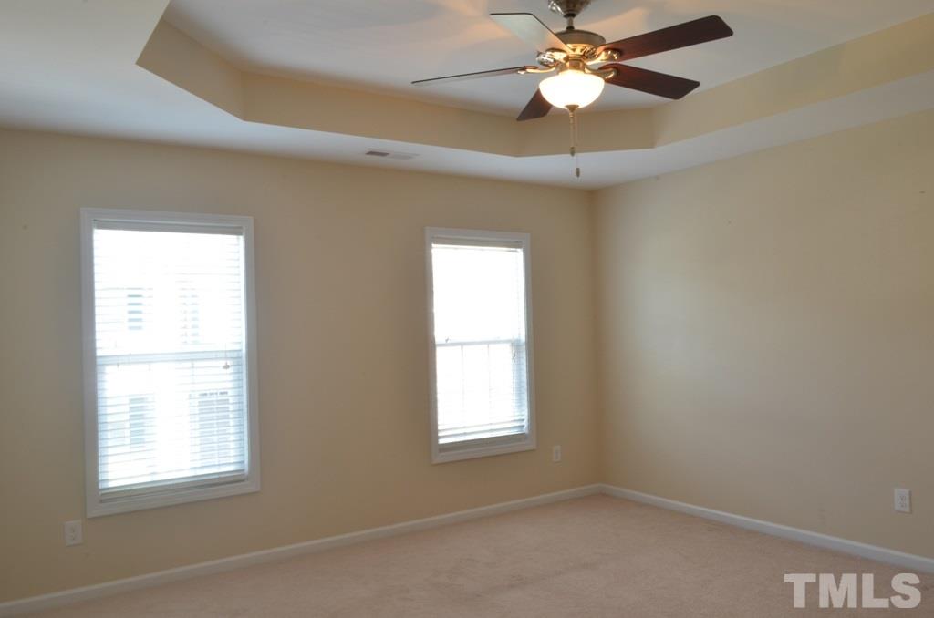 509 Dragby Lane Raleigh, NC 27603 - Photo 13 of 25 an empty room with windows and fan