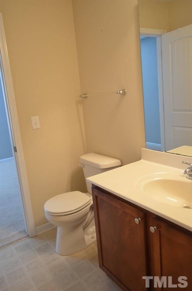 509 Dragby Lane Raleigh, NC 27603 - Photo 18 of 25 a bathroom with a sink a toilet and a mirror
