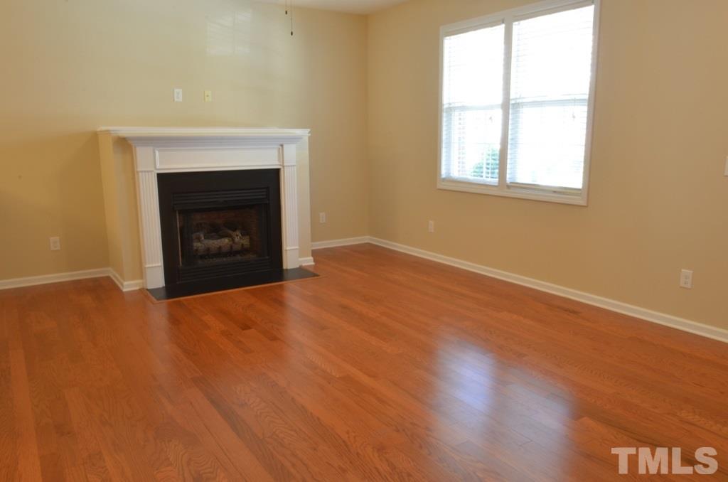 509 Dragby Lane Raleigh, NC 27603 - Photo 3 of 25 an empty room with a fireplace